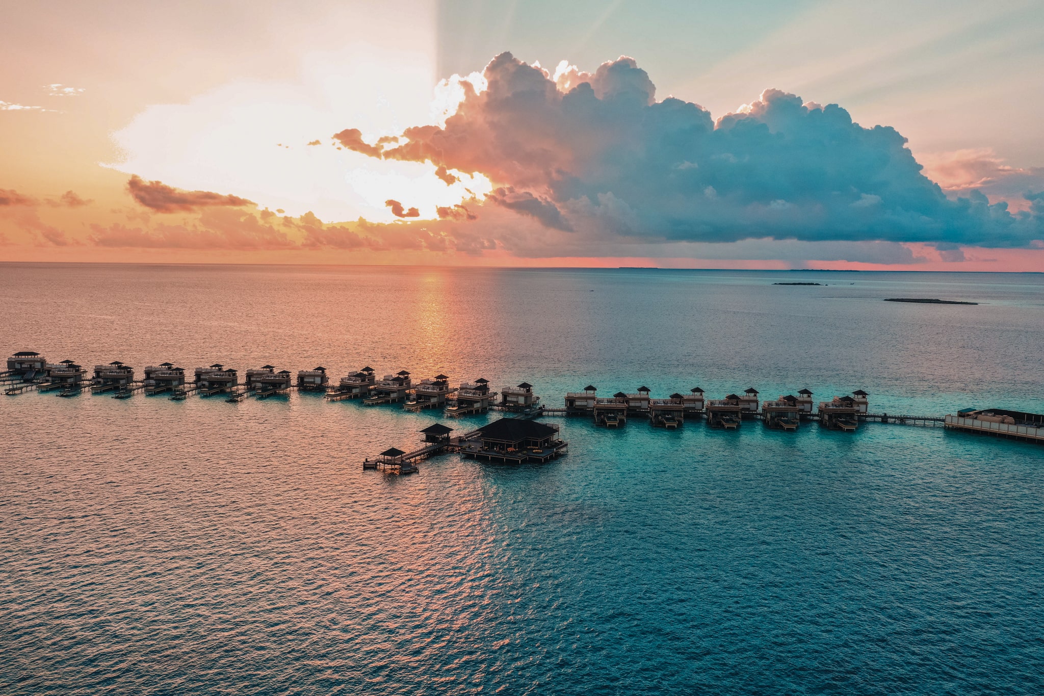 a large body of water with a series of in-ocean villas in the middle of it.